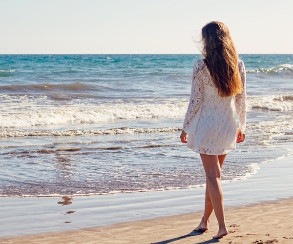 woman on beach in sundress