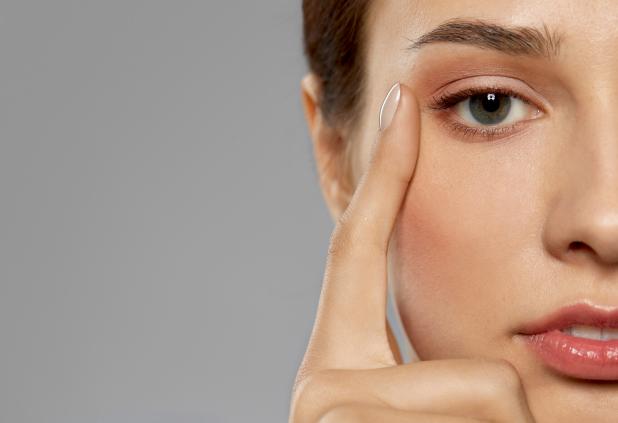 ShutterStock royalty-free image #1696017418, 'beauty, makeup and vision concept - close up of beautiful young woman face and eyes over grey background' uploaded by user #301539971, retrieved from ShutterStock on December 10th, 2023.